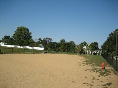 A large dirt and grass field area