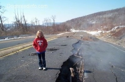 Amie standing next to the steaming crack in Highway 61