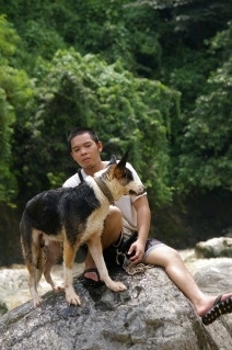 Hitman the Panda Shepherd and his owner is sitting on a rock