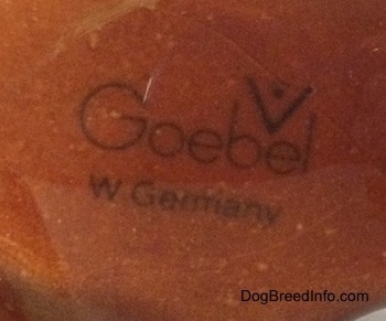 Close up - The underside of a brown Bulldog figurine. The figurine has the logo of Goebel W.Germany on it.