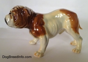The left side of a brown and white Bulldog figurine that has fine details.