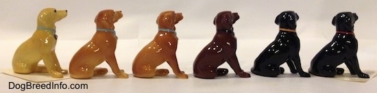 The right side of a line-up of Labrador Retrievers figurines and their different color variations. The figurines are glossy.