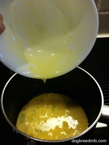 Beat egg yolks being poured into a pan
