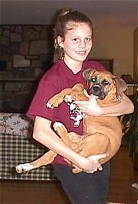 Brittany holding Allie the Boxer Puppy in her arms