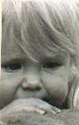 Close Up - A black and white photo of a blonde child's face