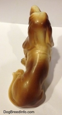 Topdown view of the back of a brown and white porcelain Basset Hound figurine.