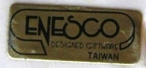 A tag with the words - Enesco designed giftware Taiwan.