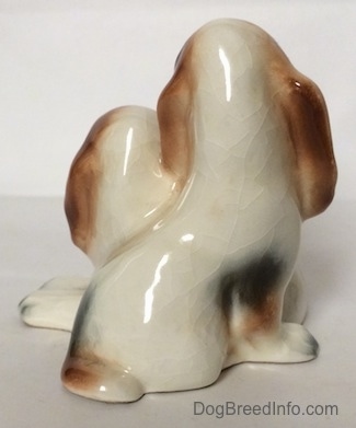The back side of a ceramic Basset Hound figurine that is two Basset Hounds. The figurine lacks fine details.