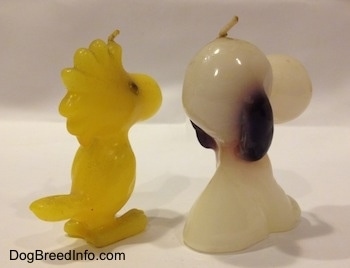 The back right side of a Snoopy and Woodstock 1970s candle set.