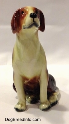 A black, brown and white porcelain Beagle figurine. The figurine has great face details.
