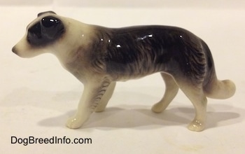 The left side of a Retired Hagen-Renaker black with white Border Collie style 1 figurine. The figurine is very glossy.