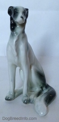 A white with black vintage Borzoi figurine. The figurine has detailed chest hair.