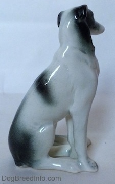 The right side of a white with black Borzoi figurine. The figurine is glossy.