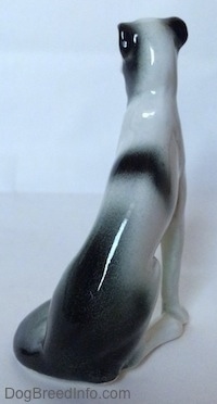 The back of a white with black Borzoi figurine. The ears of the figurine are hard to differentiate from the body.