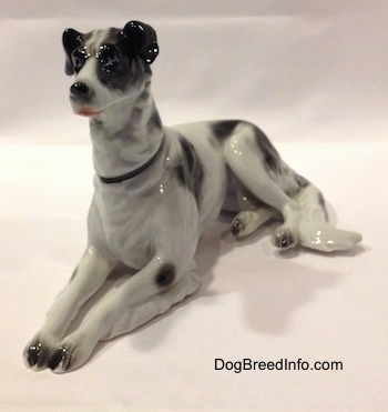 The front left side of a white with black vintage TMK-1 crown mark Borzoi. The figurine is wearing a black collar.