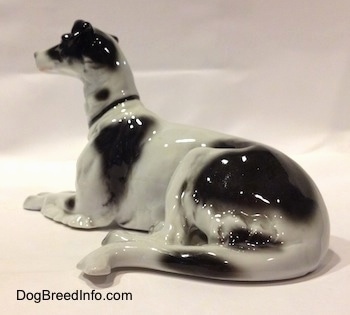 The back left side of a white with black vintage TMK-1 crown mark Borzoi. The figurine has great tail details.