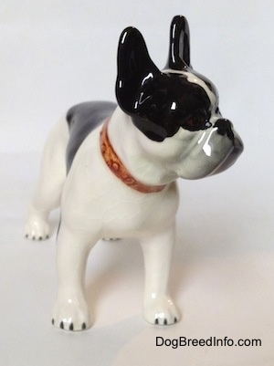 A black and white vintage 1970s TMK 5 Boston Terrier figurine. The figurine lacks paw details.