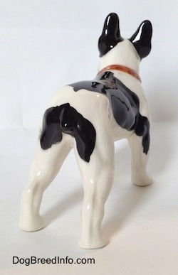 The back right side of a black and white vintage 1970s TMK 5 Boston Terrier figurine. The figurine has detailed back legs.