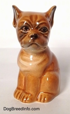 A brown Boxer puppy figurine. The figurine has black circles for its eyes.