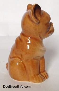 The right side of a brown Boxer puppy figurine. The figurine is all one segment.