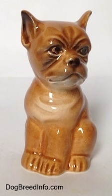 A brown Boxer puppy figurine. The figurine has very light details.