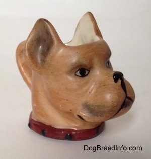 The front right side of a stein cup that is in the shape of head of a Boxer dog. The painting of the stein is realistic.