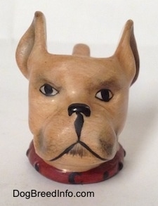 A stein cup that is in the shape of head of a Boxer dog. The eyes and the mouth of the stein are painted on.