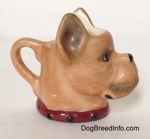 The right side of a stein cup that is in the shape of head of a Boxer dog. The stein has a collar painted on it.