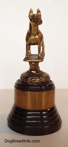 The left side of a Bull Terrier Club trophy that has a golden Bull Terrier statue at the top.
