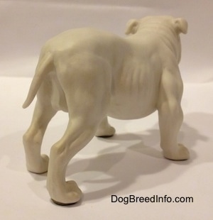 The back right side of a white bisque porcelain Bulldog figurine. The figurine has yet to be painted.