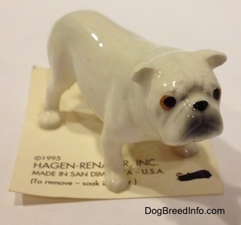 A white miniature Bulldog figurine. The figurine has copper and black eyes.