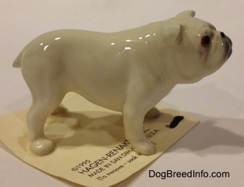The right side of a white miniature Bulldog figurine. The figurines ears are hard to differentiate from the head.
