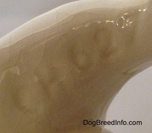 Close up - The underside of a Bulldog figurine and there is a number engraved on it. That number is - CH627.