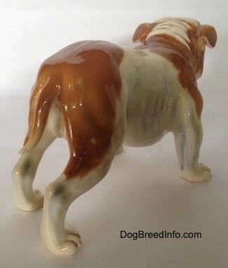 The back of a brown and white Bulldog figurine. The figurine is glossy.