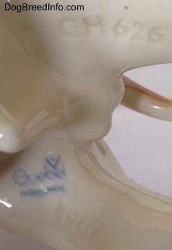Close up - The underside of a Bulldog figurine. On the underside of the figurine is the logo for Goebel W.Germany.