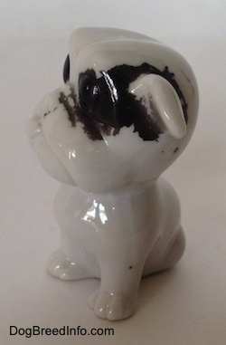 The left side of a white with black bone china Bulldog figurine.