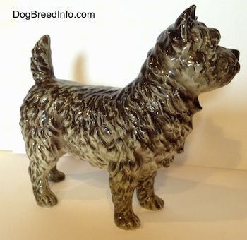 The right side of a black and white Cairn Terrier figurine. The figurine has detailed hair.