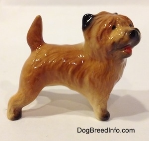 The right side of a brown with black Cairn Terrier figurine. The tips of the figurines ears are black.