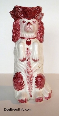 The white and red Cavalier King Charles Spaniel porcelain water pitcher.