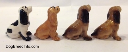 The right side of four color variations of a Cocker Spaniel figurine. All of the figurines are glossy.