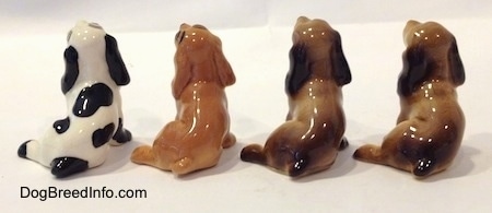 The back of four color variations of a Cocker Spaniel figurine.