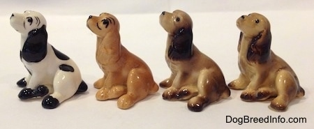 The left side of four color variations of a Cocker Spaniel figurine. They were made to look up and to the left.