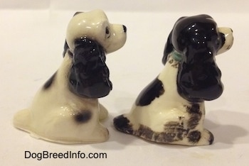The right side of two different ceramic Cocker Spaniel figurines. The ears of the figurines have fine details.