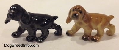 The left side of two different ceramic Cocker Spaniel puppy figurines. They are very glossy.