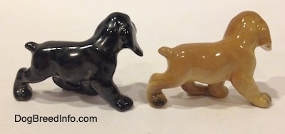 The right side of two different ceramic Cocker Spaniel puppy figurines. They are very glossy.
