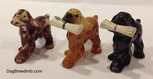 The front left side of three different Cocker Spaniel figurines.