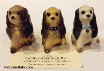 Three different ceramic Cocker Spaniel puppy figurines. The figurines have very detailed hair brushings.