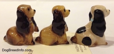 The right side of three different Cocker Spaniel puppy figurines. The ears have light details.