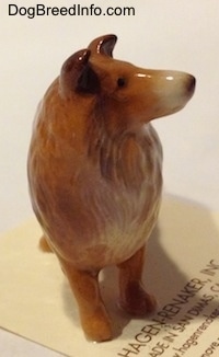 A brown with white Collie dog figurine.