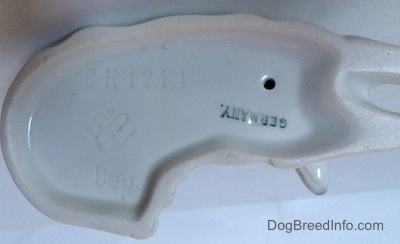 The underside of a Collie dog figurine. On the underside there is a Goebel crown mark, the word - Germany - and the engraved letter/number combination - CH1241.